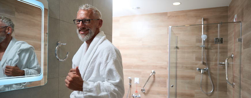 Life Assure Senior Man Wearing Bathrobe In Bathroom Hero